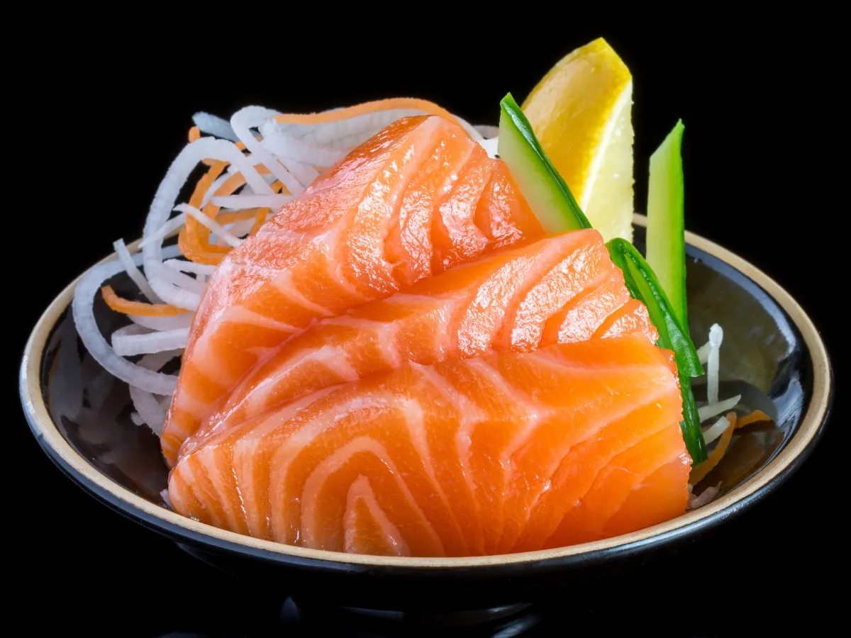 Fresh salmon sashimi with garnishes at Umami Sushi & Ramen Bar, a Japanese Restaurant in Georgetown